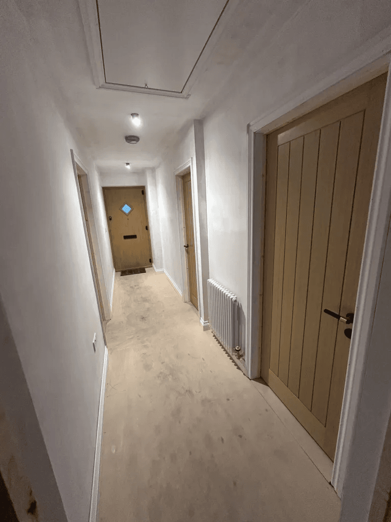 A finished hallway with fitted timber doors