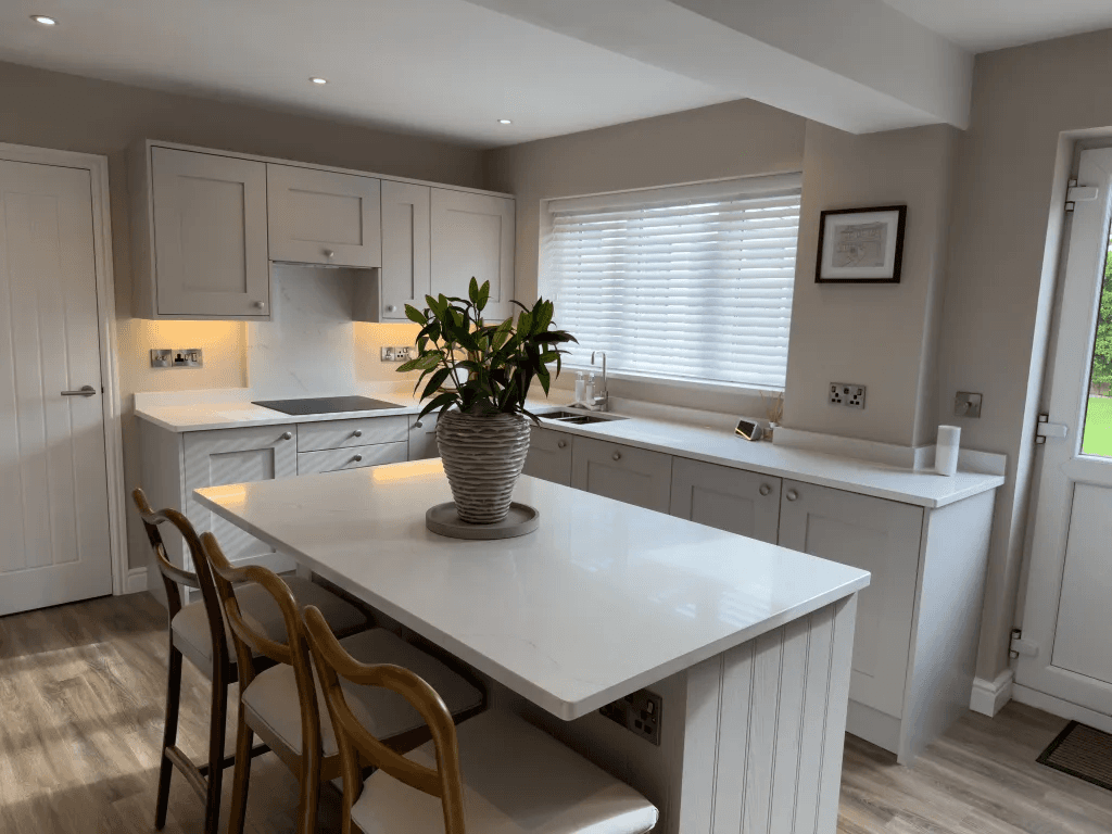A refurbished white shaker kitchen with an island and fitted storage